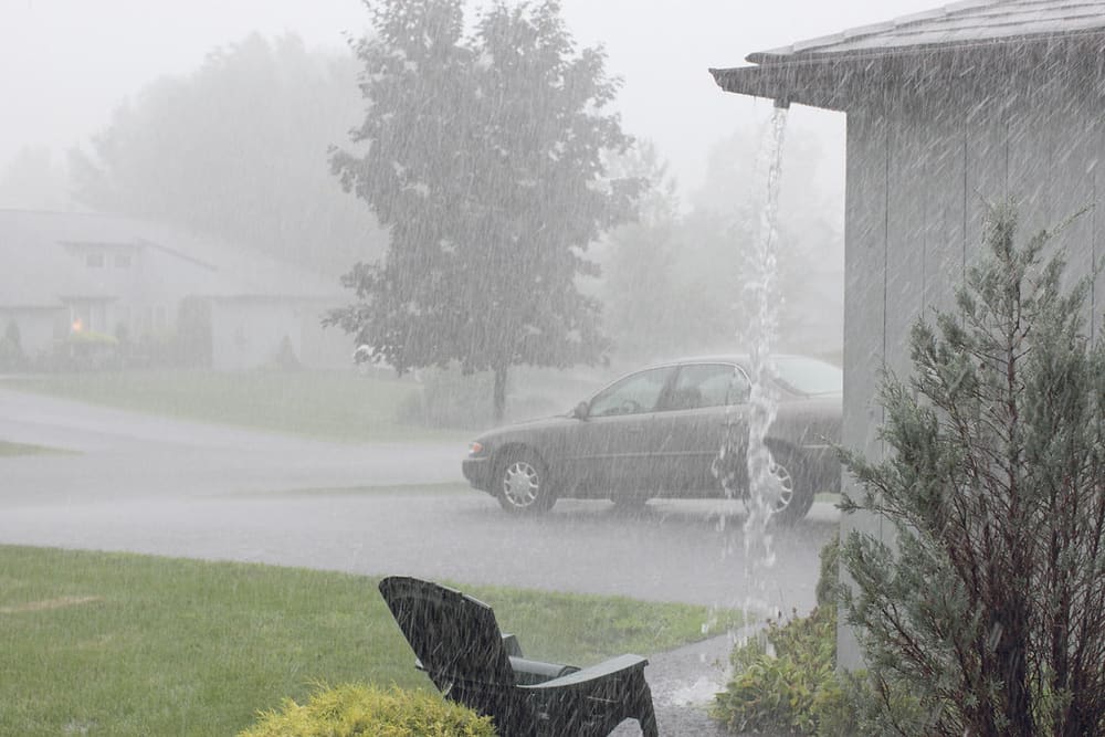 Downspout carrying rainwater during heavy rain