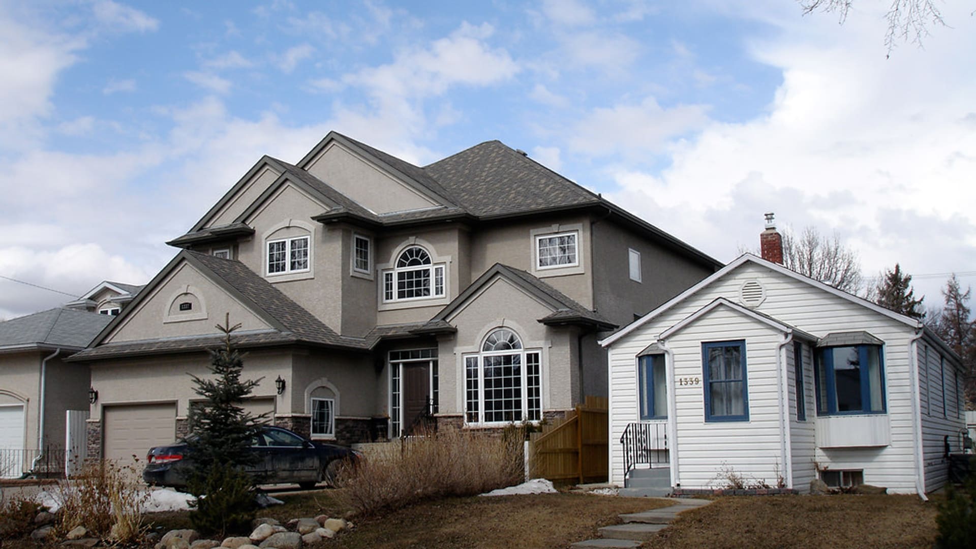 Two-story home with a steep shingle roof