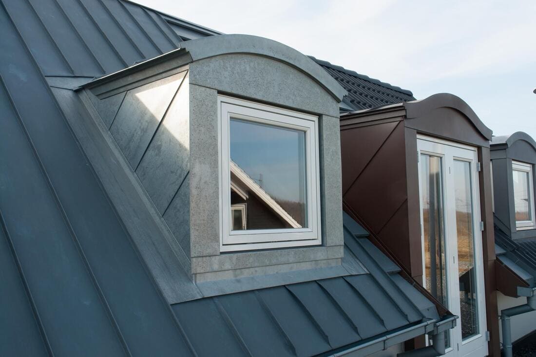 Standing-seam metal roof sections around dormers